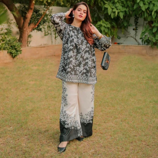 Woman in a floral outfit standing outdoors with greenery in the background
