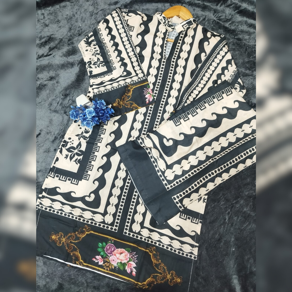 Black and white patterned garment with floral designs on a textured surface