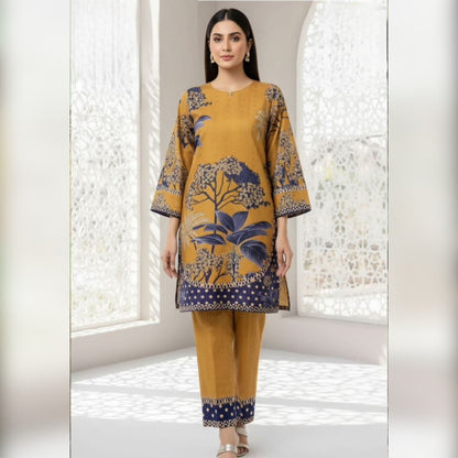 Woman wearing a mustard yellow and blue patterned outfit in a bright room.