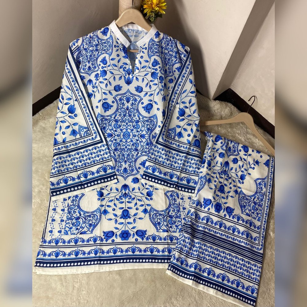 Blue and white patterned shirt and skirt set on hangers against a neutral wall.