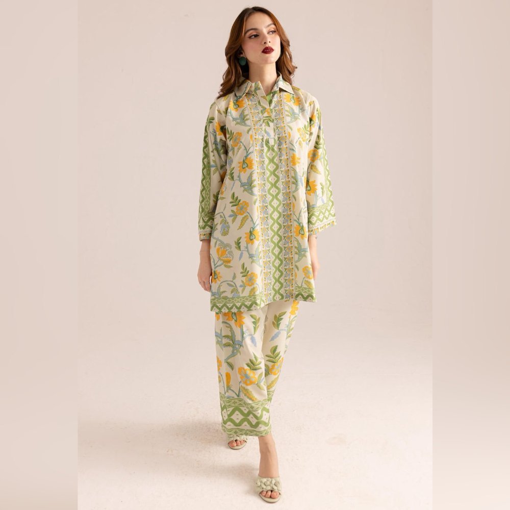 Woman wearing a floral outfit with green and yellow patterns on a beige background