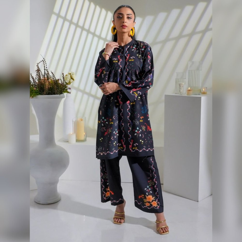 Woman wearing a dark floral outfit in a bright room with white decor