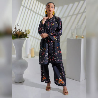 Woman wearing a dark floral outfit in a bright room with white decor