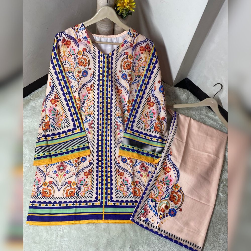 Colorful embroidered garment on a hanger against a neutral background