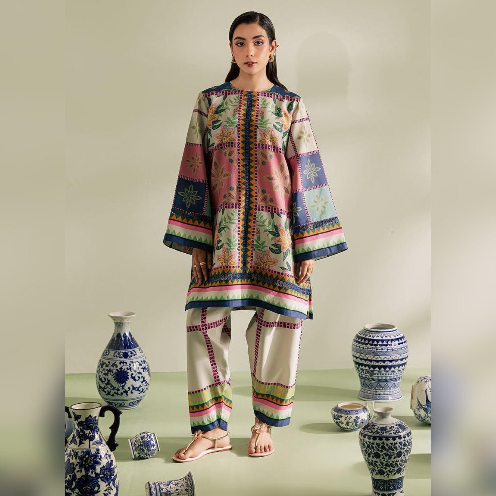 Woman wearing a colorful traditional outfit with decorative vases in the background