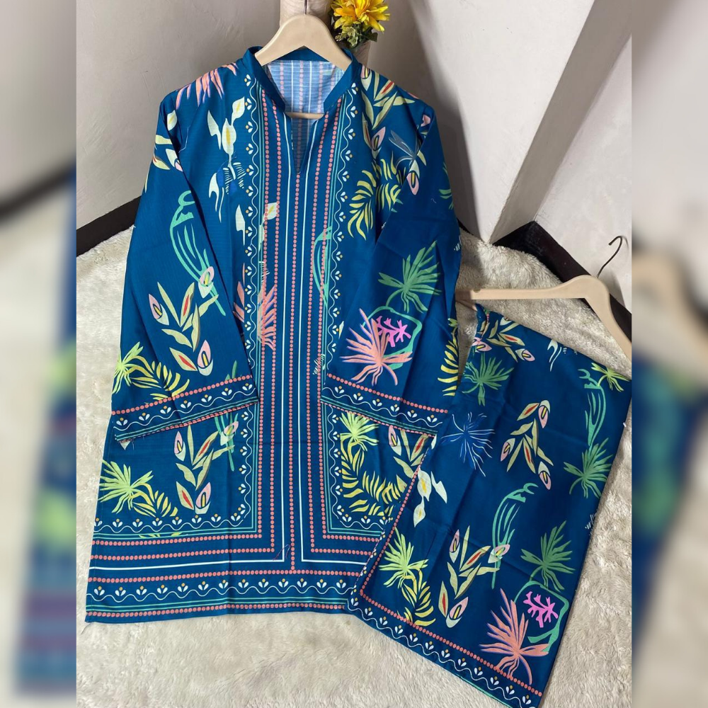 Blue embroidered garment with colorful patterns on a hanger against a neutral background