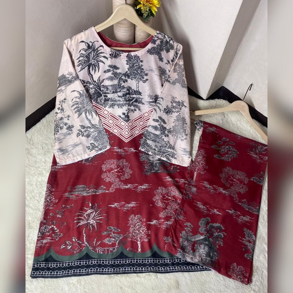 Two patterned dresses on hangers against a white wall.