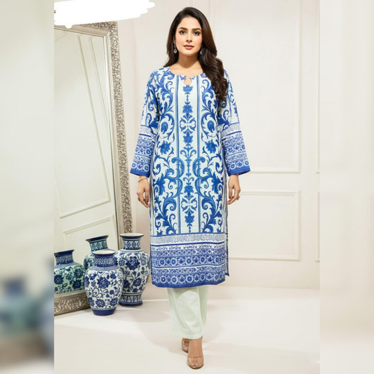 Woman wearing a blue and white patterned kurta with light green pants in a room with decorative vases.
