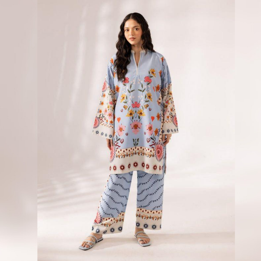 Woman wearing a floral embroidered outfit on a plain background