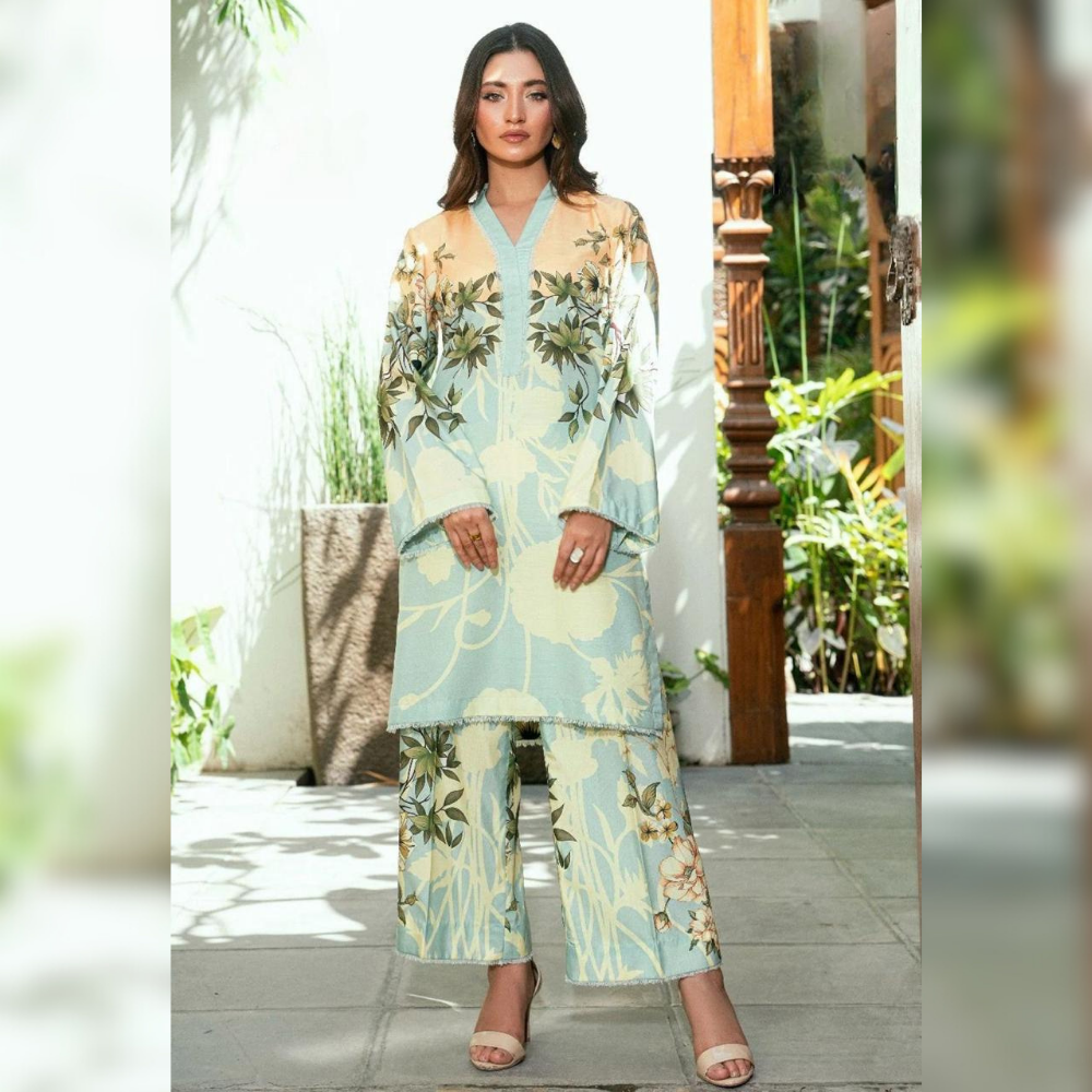 Woman wearing a floral outfit standing in a garden setting