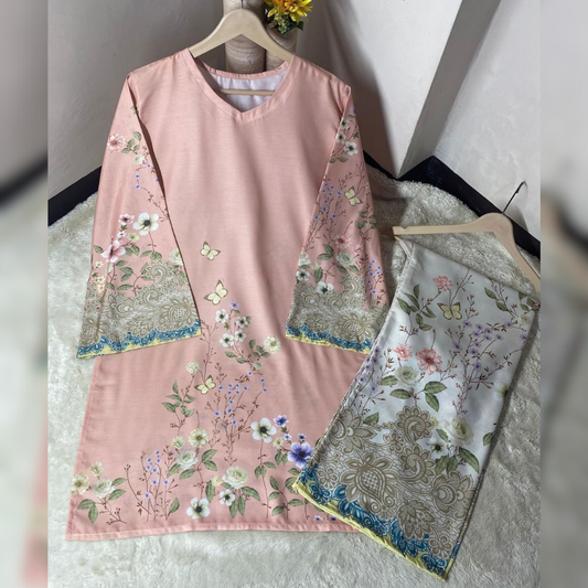 Pink embroidered dress with floral patterns on a hanger against a neutral background