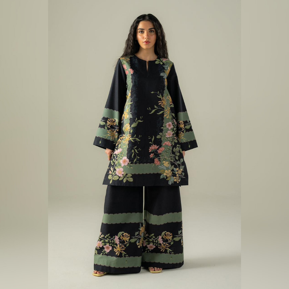 Woman wearing a black floral outfit on a beige background