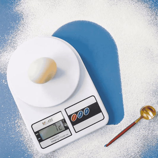 Digital kitchen scale with an egg on a blue background