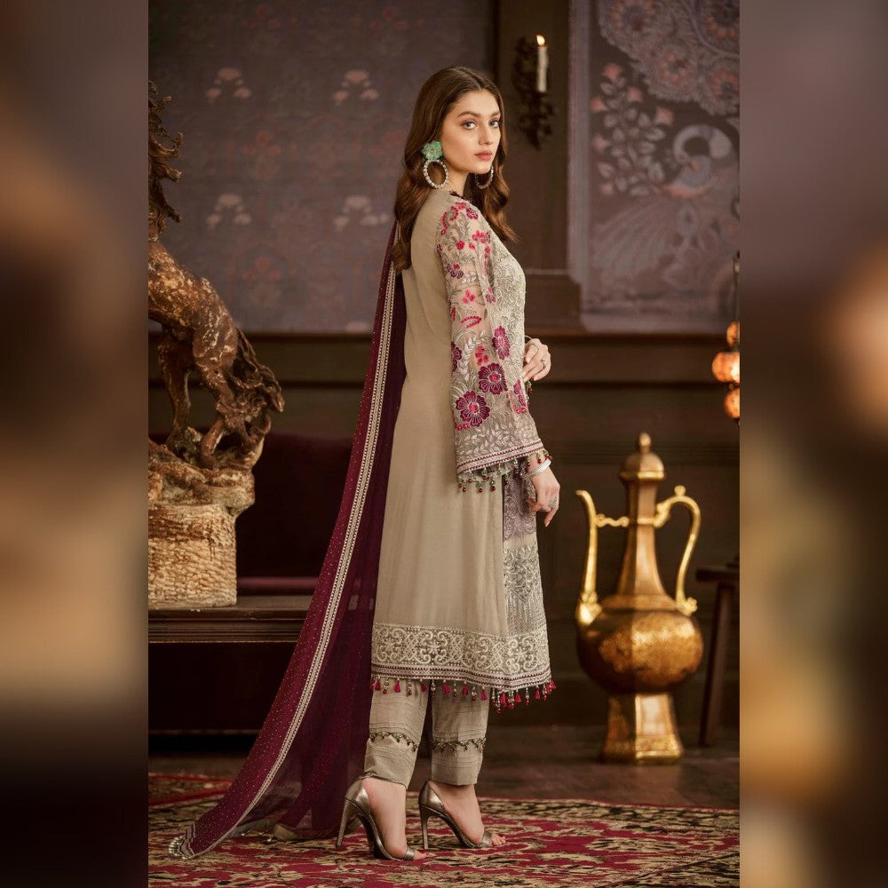 Woman in traditional outfit with floral patterns in a decorative setting