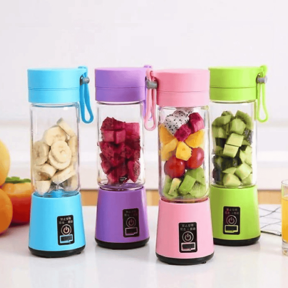 Four colorful portable blenders with fruits inside on a white surface.
