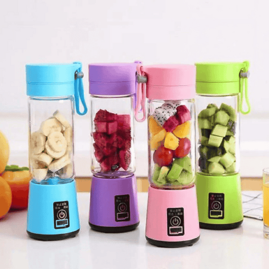 Four colorful portable blenders with fruits inside on a white surface.