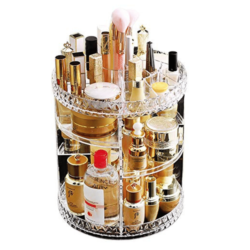 Rotating acrylic cosmetic organizer with various skincare and makeup products on a white background