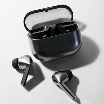 Wireless earbuds with charging case on a light background