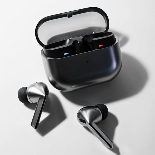 Wireless earbuds with charging case on a light background