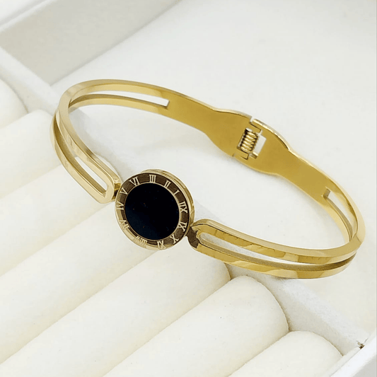 Gold bangle with twin black stones on the sides