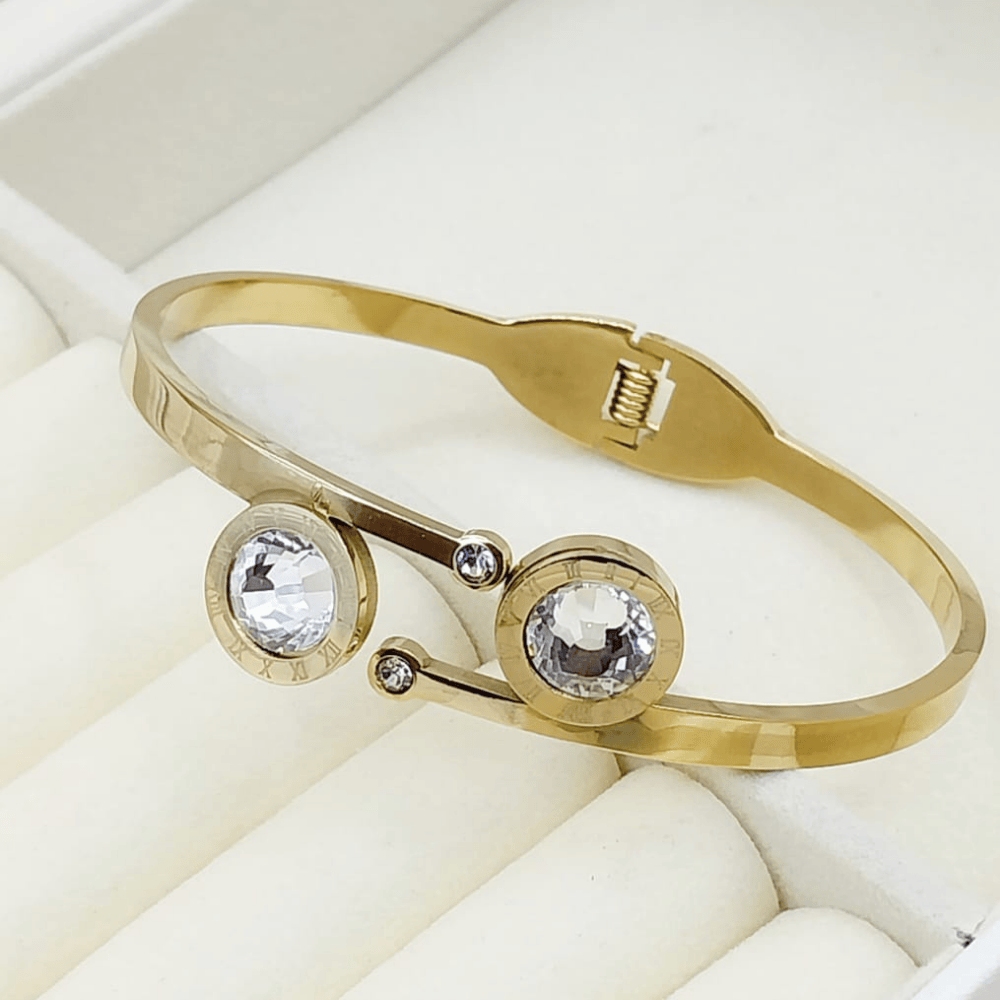 Gold bangle featuring silver stones on both sides
