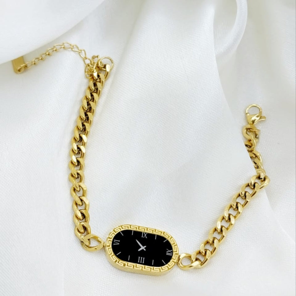 Gold chain bracelet with a black clock face on a white background
