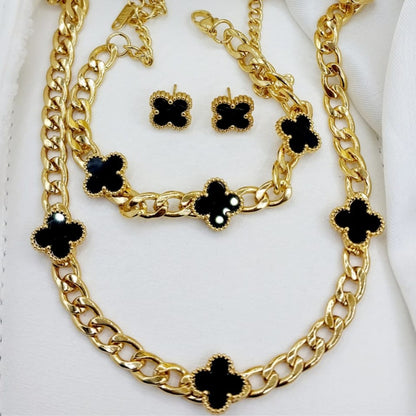 Gold necklace with black clover-shaped pendants on a white background