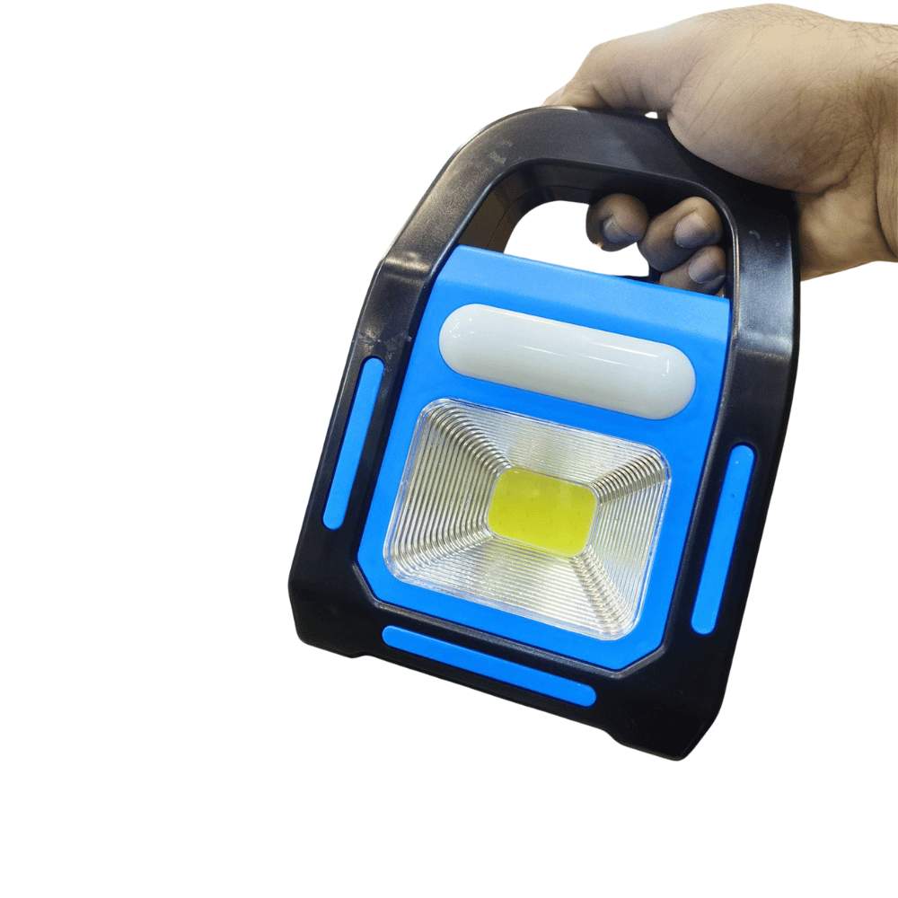 Hand holding a portable work light with blue accents on a white background