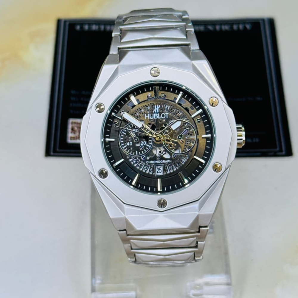 Hublot watch with silver metal band and black face on a white background