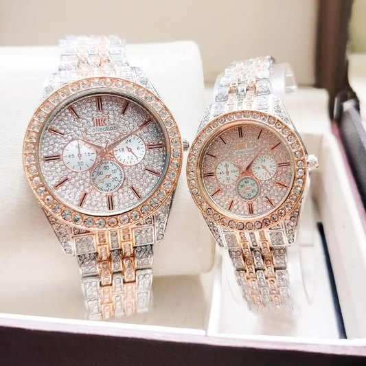Two ornate watches with diamond-studded faces on a white surface.