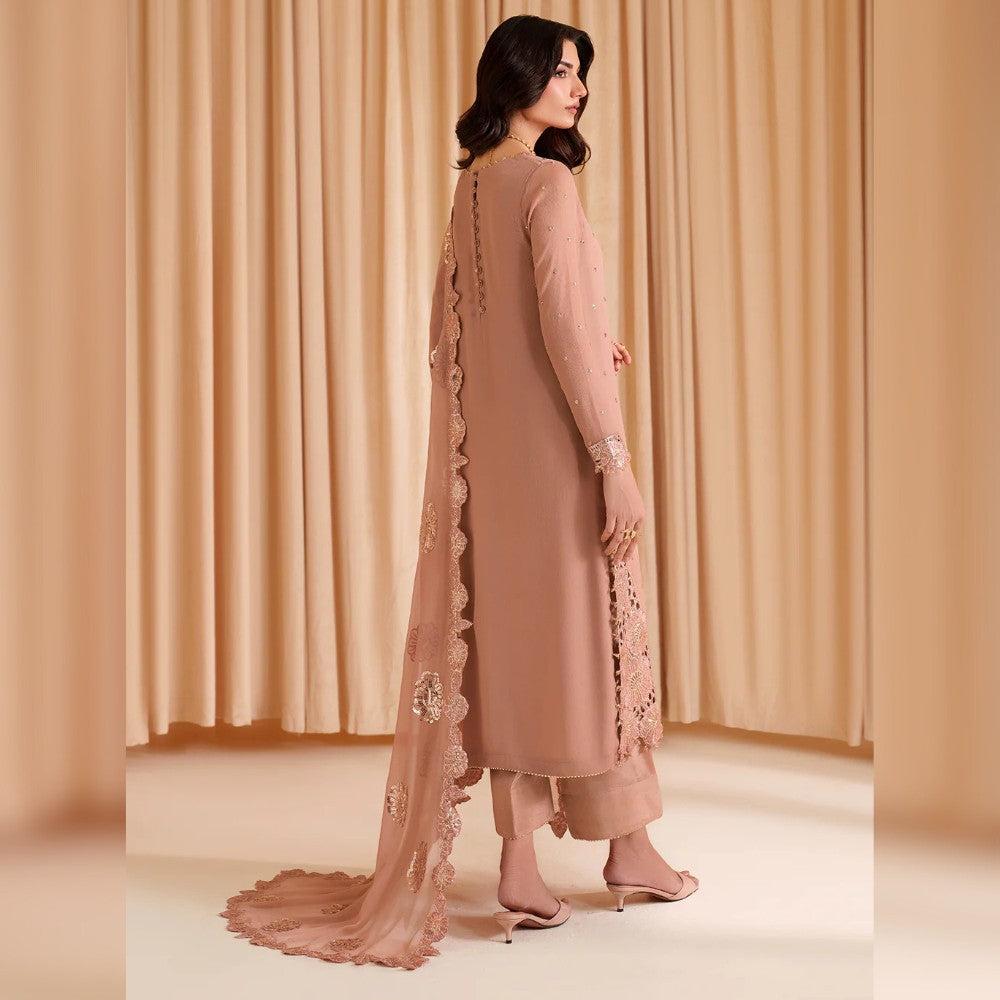 Woman wearing a beige traditional outfit with a long scarf against a beige curtain background