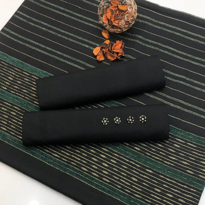 Two black cylindrical objects with paw print designs on a green striped surface.
