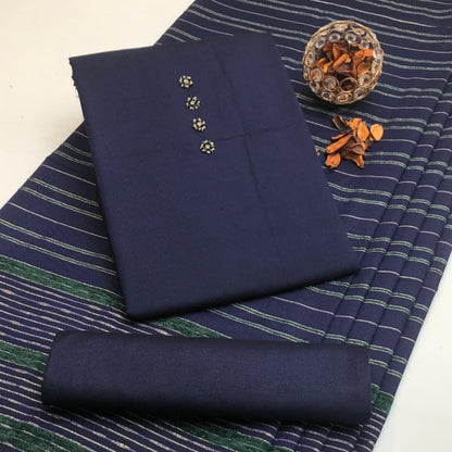 Navy fabric with decorative buttons on a striped fabric background