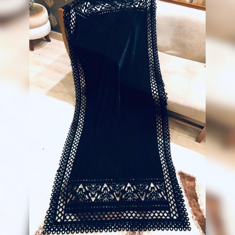 Navy blue dress with lace detailing on a blurred indoor background