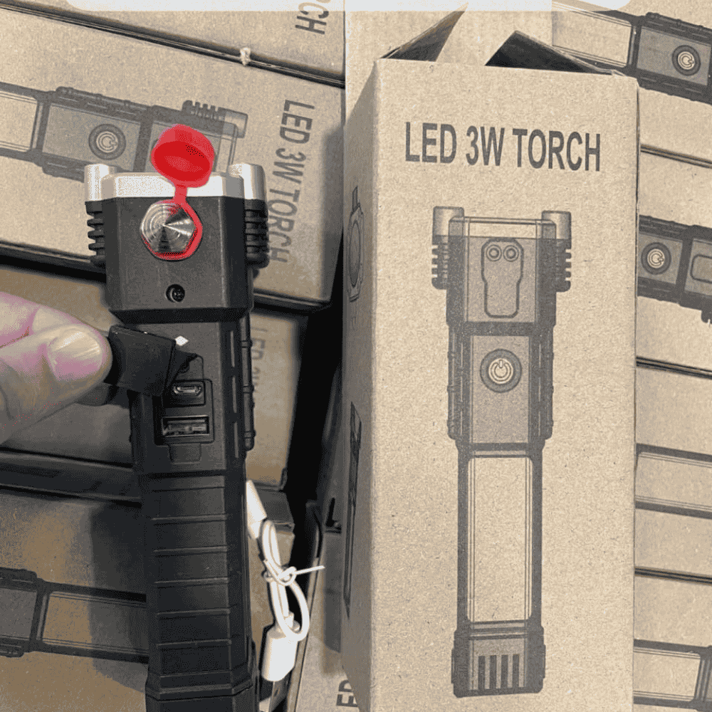 Flashlight displayed with its packaging box, showing included accessories.