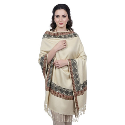 Woman wearing a cream-colored shawl with intricate patterns on a white background