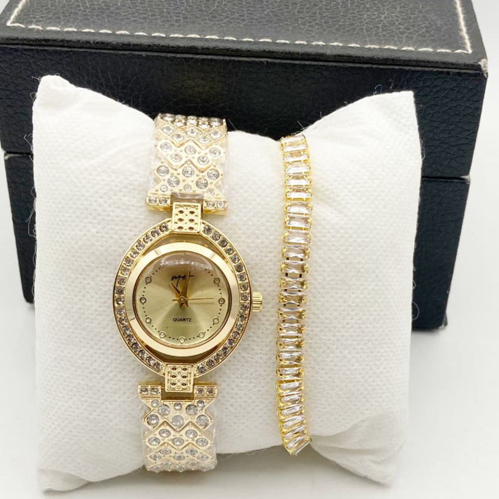 Gold watch and bracelet set on a white cushion with a black box in the background