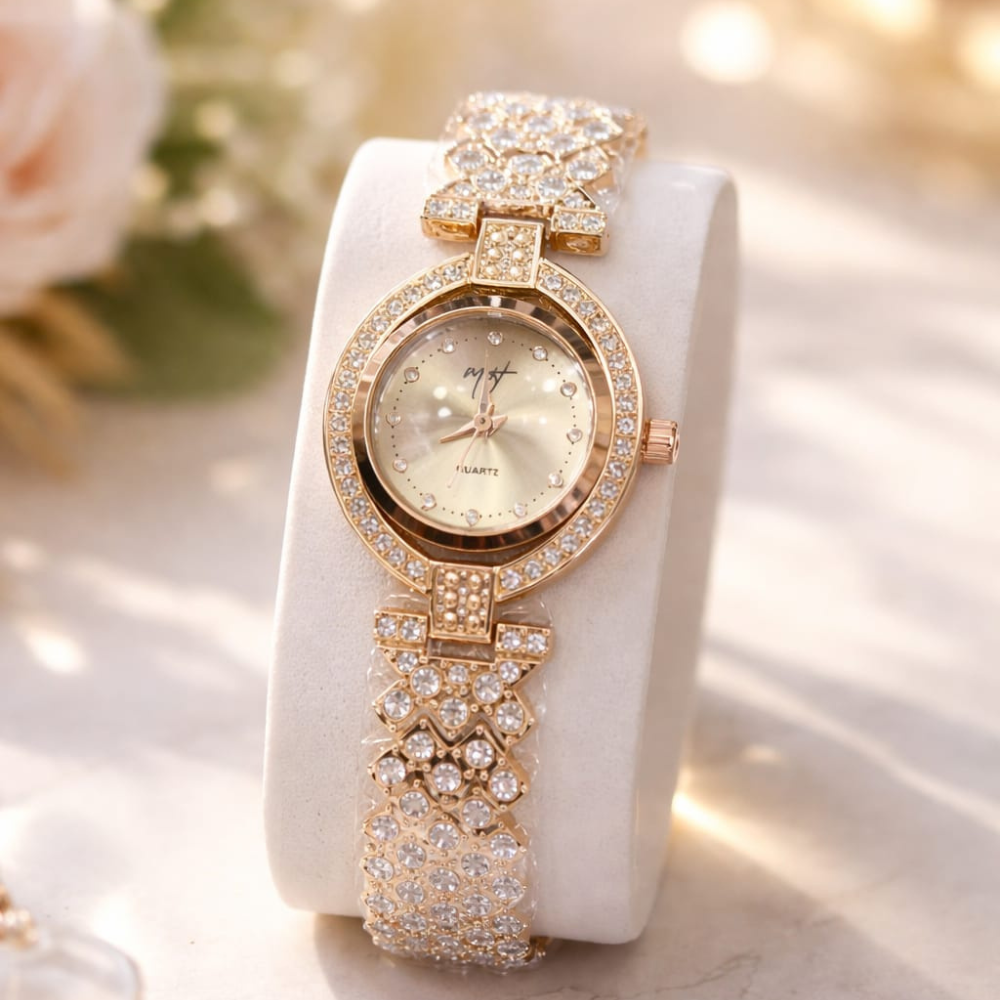 Rose gold watch with diamond accents on a white stand with blurred floral background