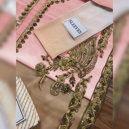 Decorative fabric with gold embroidery on a pink background, labeled 'SLEEVES'.