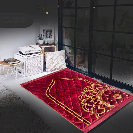 Red prayer mat with gold patterns in a room setting