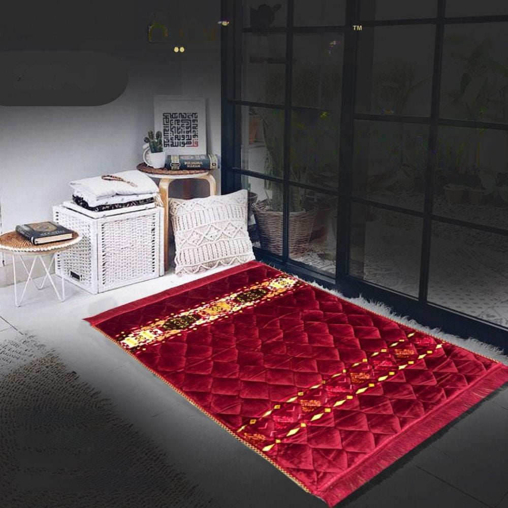 Red patterned rug on a dark floor with a white wall and furniture in the background