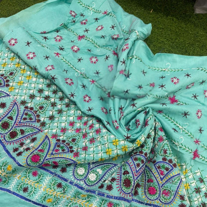 Turquoise fabric with intricate patterns on a green background