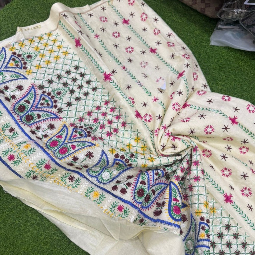 Embroidered fabric with colorful patterns on a green surface