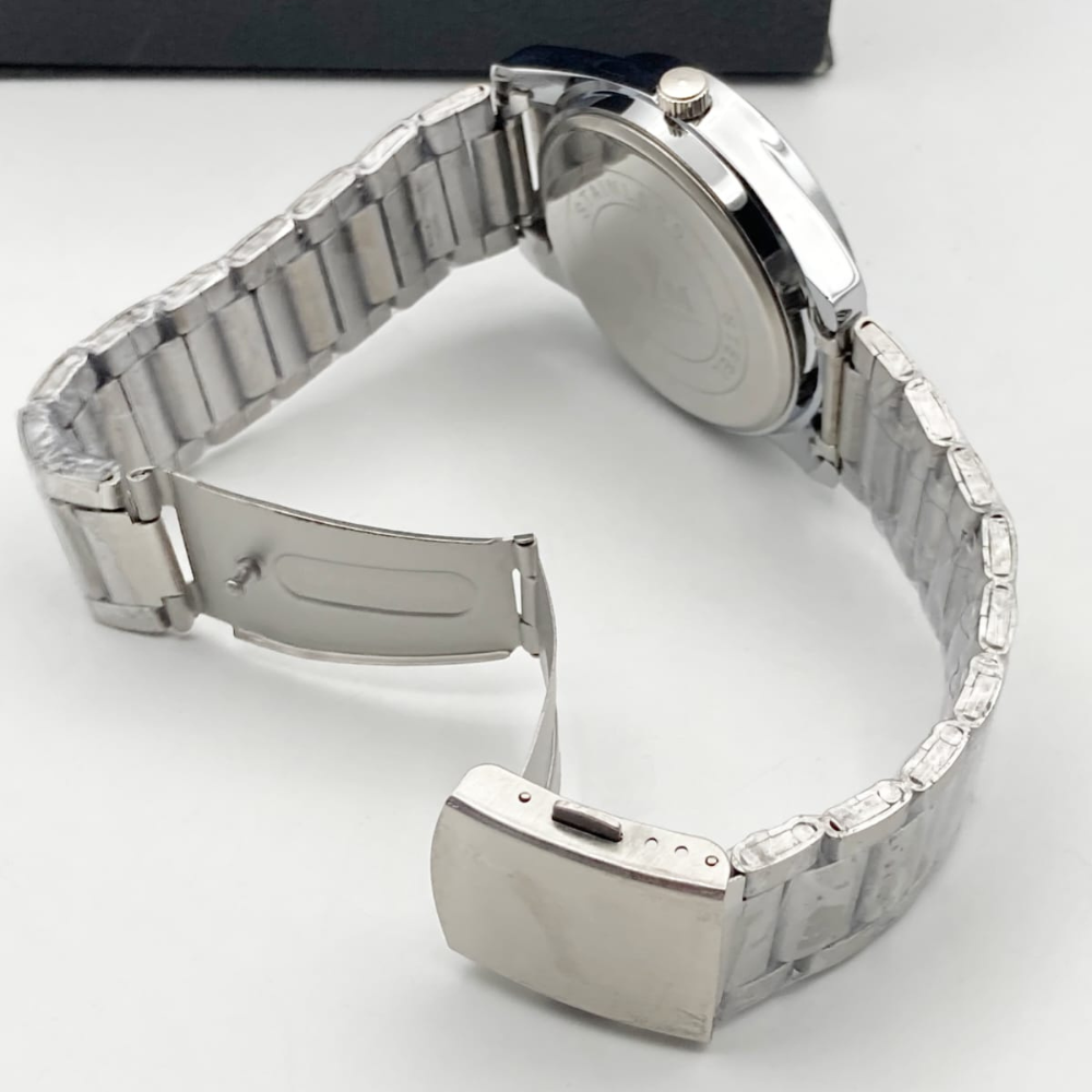 Close-up of a silver watch band on a white background