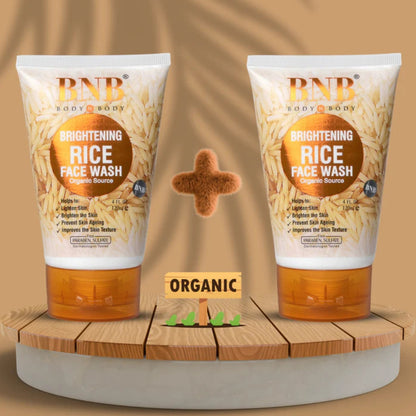Two bottles of RNB Brightening Rice Face Wash on a wooden platform with a brown background.