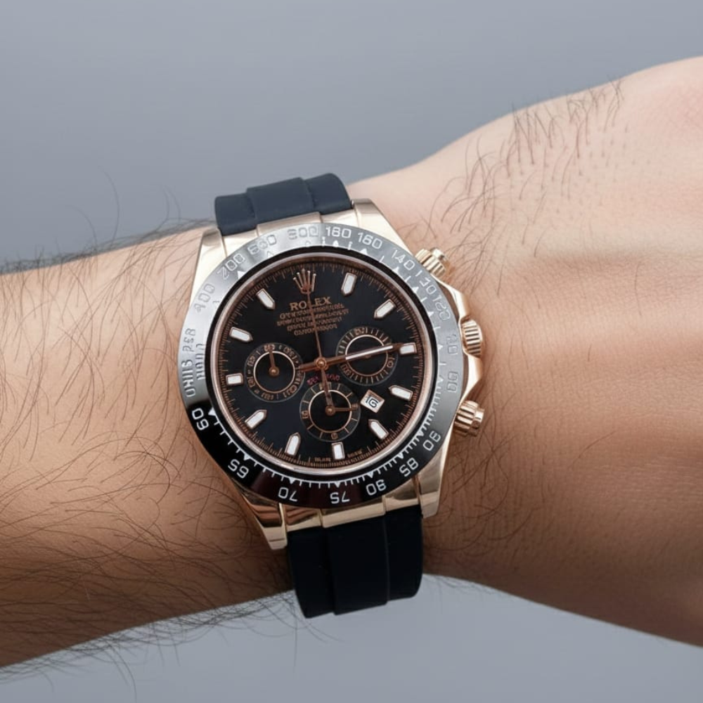 Luxury watch with black strap on a wrist against a neutral background