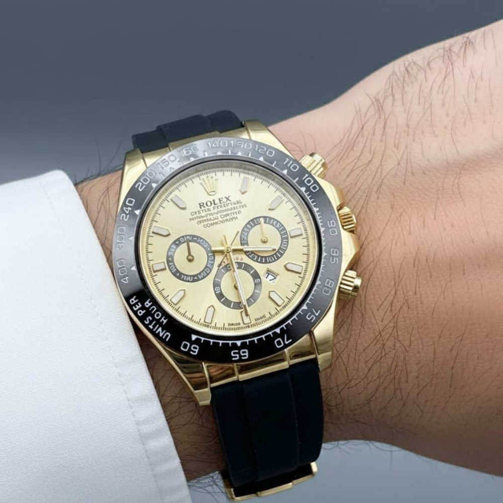 Luxury watch with gold and black strap on a wrist against a neutral background
