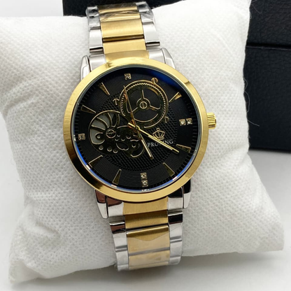 Gold and silver watch with black face on a white cushion