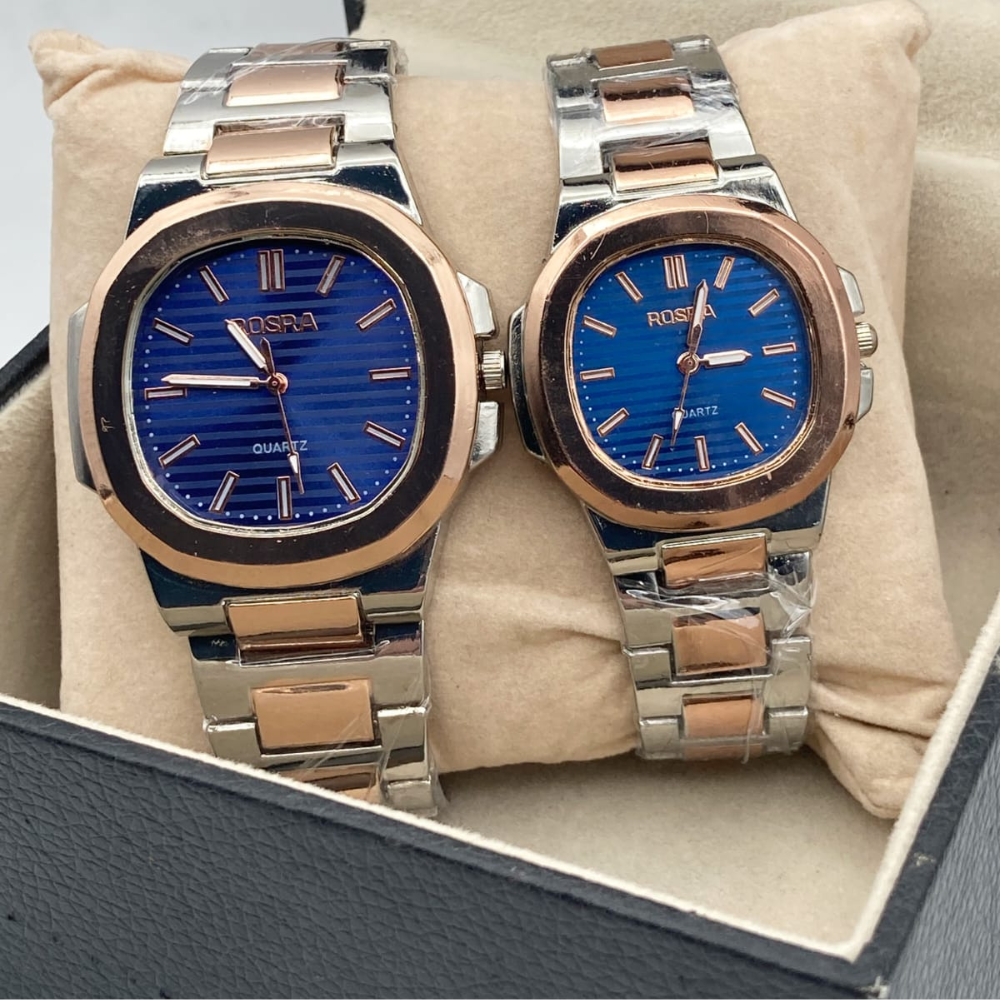 Two Rosra watches with blue faces and rose gold and silver bands in a box.