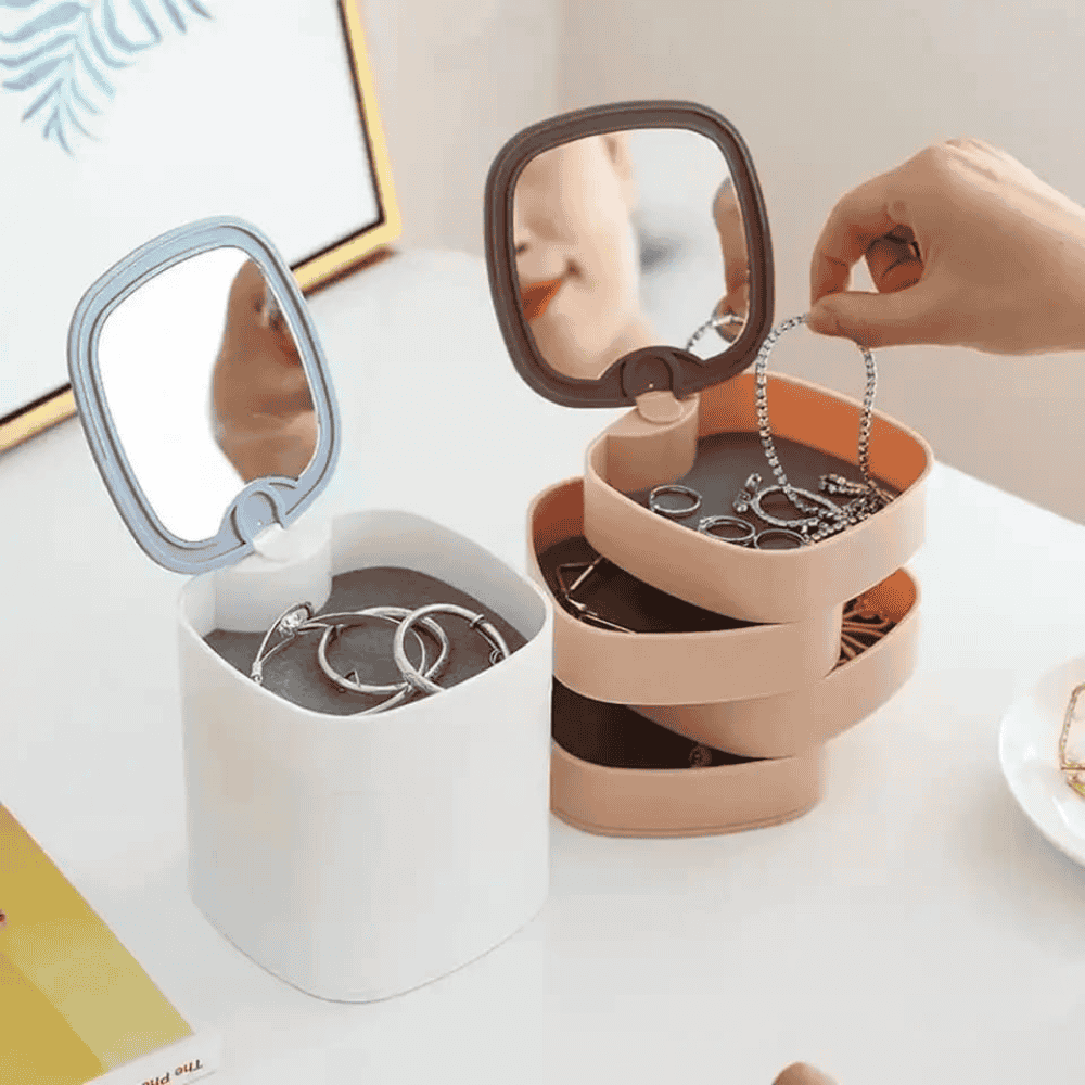 Jewelry organizer with mirror and jewelry on a white surface